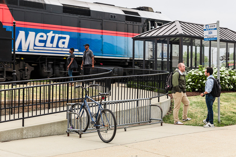 Metra train passes by Pace bus stop