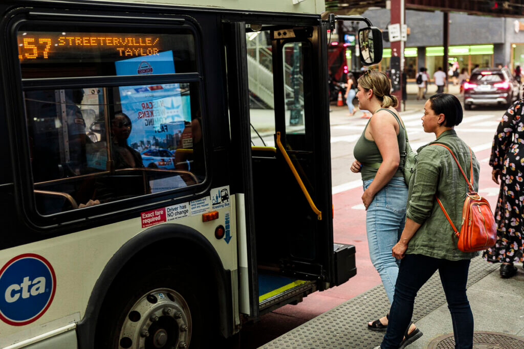 Two women boarding a bus